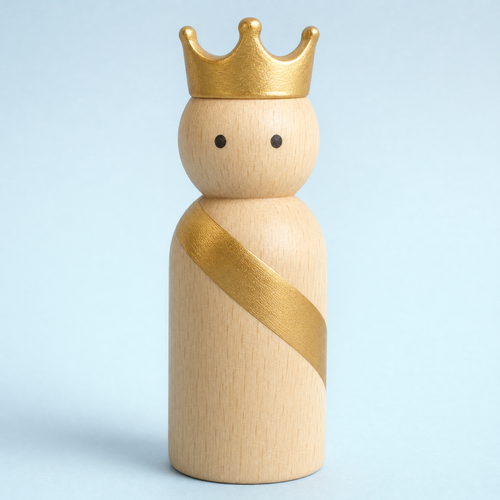 Jorlaxis Crowned King: a pale wooden peg figure with a gold crown and sash