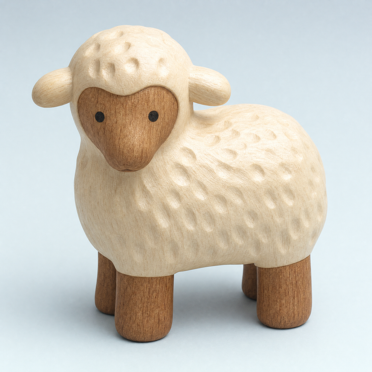 Jorlaxis Lamb: a cream wooden lamb with a hand-carved fleece and a darker face