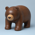 Jorlaxis Bear: a large walnut-brown wooden bear with a pale muzzle and small round ears